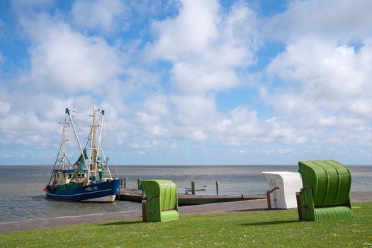 Panoramic image of the landscape along the dikes of Pellworm with beach chairs, North Frisia, Germany 