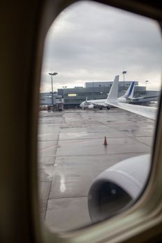 1.04.2022. Vnukovo Airport, Moscow. The view from the plane window to the parking lot where the planes are serviced and preparing for takeoff.