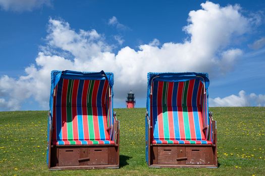 Panoramic image of the landscape along the dikes of Pellworm with beach chairs, North Frisia, Germany 