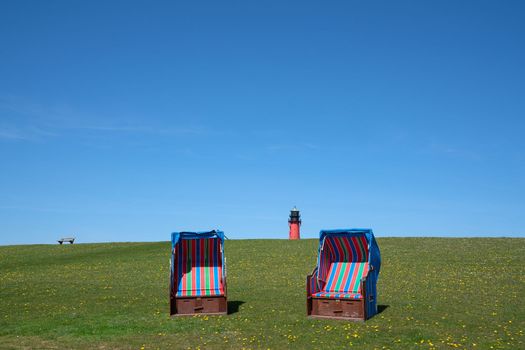 Panoramic image of the landscape along the dikes of Pellworm with beach chairs, North Frisia, Germany 