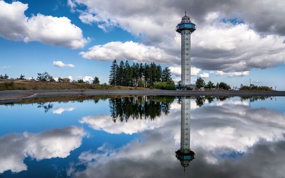 Heather tower close to Willingen with reflection and cloudy sky, Sauerland, Germany