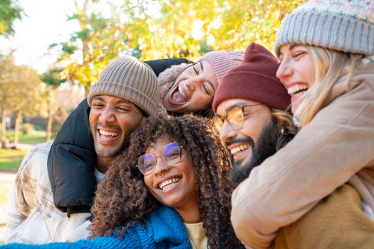 Cheerful group of friends taking smiling selfie. Happy people having fun together outdoors on vacation holidays. Concept of community, youth lifestyle and friendship. High quality photo