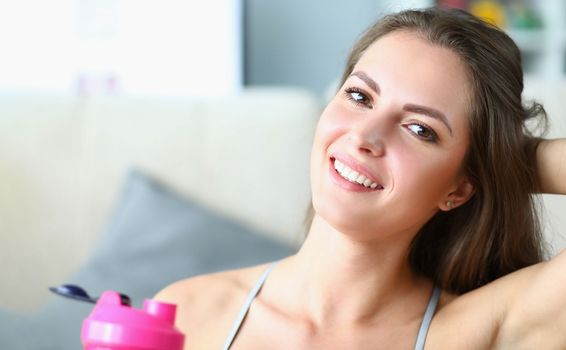 Portrait of beautiful young smiling sportswoman woman. Positive mood at sports training