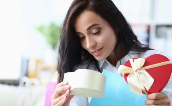 Beautiful woman opens gift box. Surprise for valentine day and birthday concept