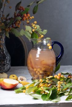 Assorted compote of apples and Japanese quince in a jug, delicious, vitamin drink, chaenomeles. High quality photo
