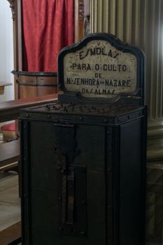 The ancient wooden alms-box at the Church of the Virgin Mary in Nazare