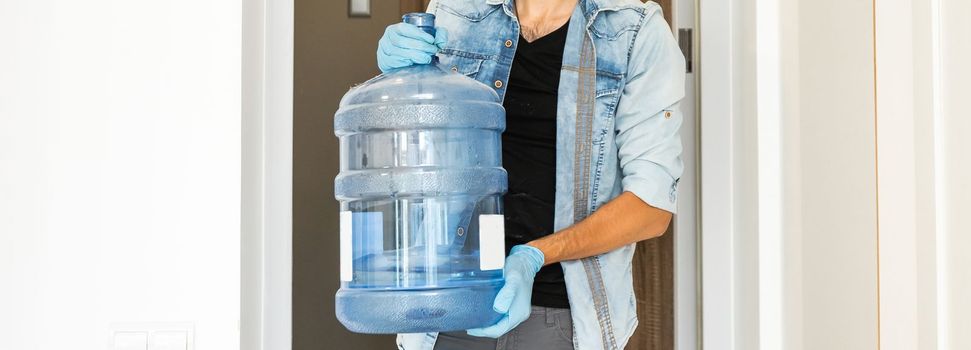 Delivery water man wear protective face medical mask during coronavirus pandemia.