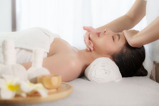 Young woman doing relaxing massage in spa salon. Female being massaged by a masseur. Spa and medicine concept.
