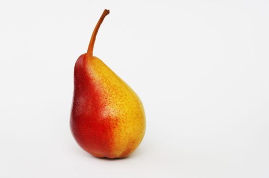 Ripe attractive red-yellow pear on a white background.