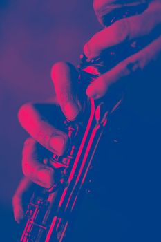 the hands of a musician on the clarinet - an ancient musical wooden instrument popular in classical brass marching jazz folk music, loved by children and adults, amateurs and professionals.. High quality photo