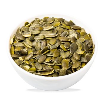 Bowl of pumpkin seeds isolated on white. Top view. Organic food