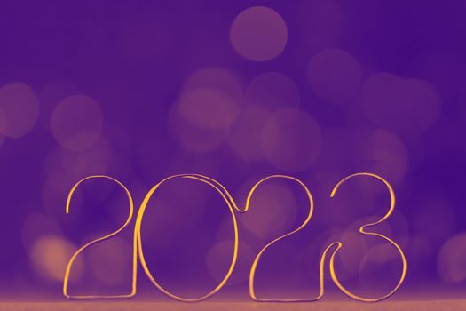 Happy New Year 2023. Beautiful holiday template web banner or billboard with Golden number 2023 on festive blue background with copy space for text. High quality photo