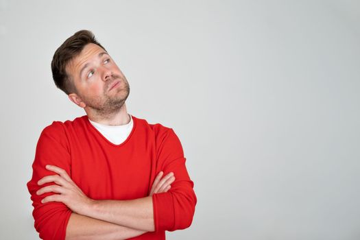  Handsome young man smiling while standing isolated on white background. Positive facial human emotion