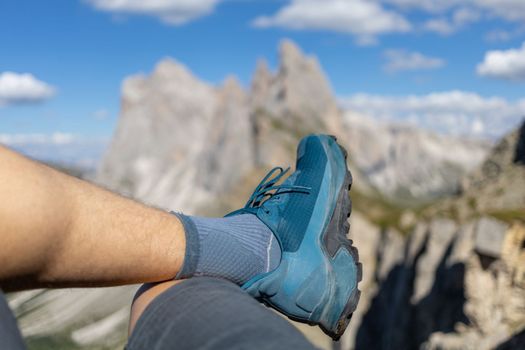 relaxing hiker legs against summer Dolomites peaks High quality photo