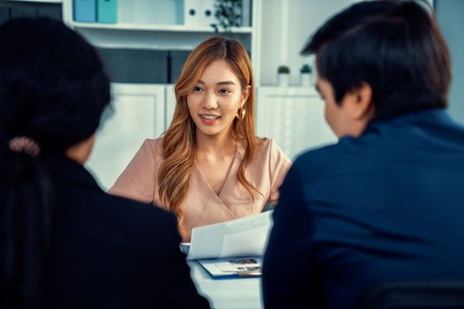 A young female asian candidate tries to impress her interviewer by being competent. International company, multicultural environment in workplace.