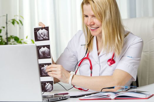Female doctor showing her patient picture of ultrasound image of her baby on the laptop. teletreatment. gynecology gynecologist education medicine healthcare feminine health pregnancy preparation prevention.