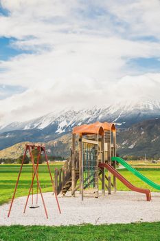 playground with slides against the backdrop of the Julian Alps in Slovenia.