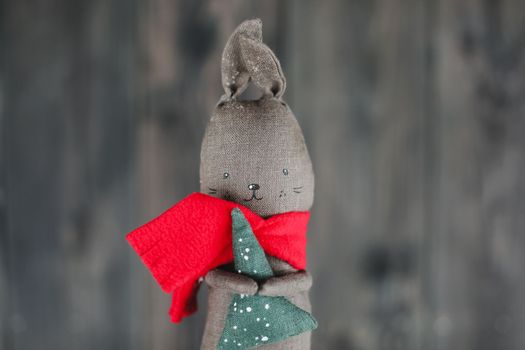 Toy rabbit on dark background. Symbol of 2023, Happy New Year and Christmas card, banner. 