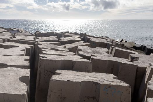 breakwater concrete blocks in the ocean sunny day. High quality photo