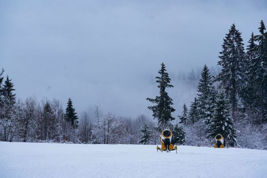 Mountains Winter mountains panorama with ski slopes and ski lifts among spruce forest on a background of mountain ranges and sky in Germany Hessen Rhoen on Wasserkuppe . High quality photo. High quality photo