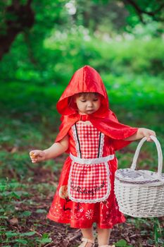 Charming baby in a red riding hood costume.