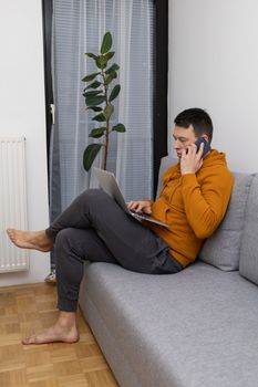 young man watching at laptop playing game. High quality photo