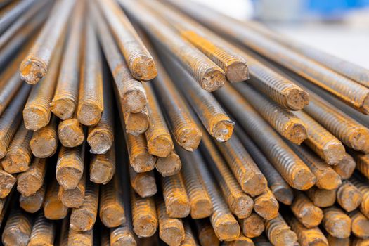 A large bundle of iron construction fittings in close-up. A bunch of new construction iron fittings on the construction site. High quality photo