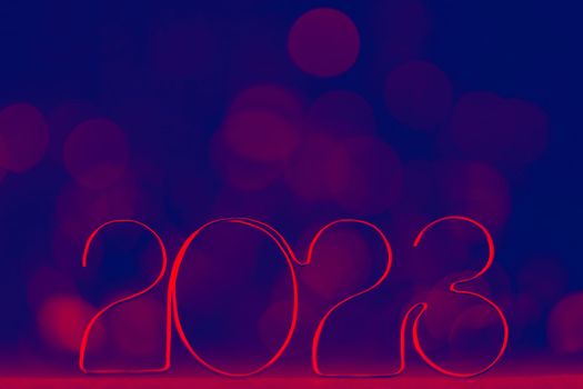 Happy New Year 2023. Beautiful web banner or billboard template with red number 2023 on blue background with copy space for text. High quality photo