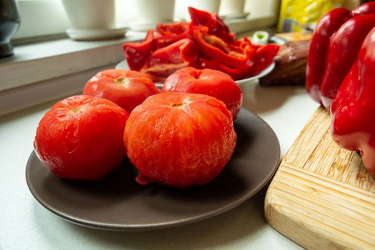 Scalded peeled fresh red tomatoes on a plate as an ingredient