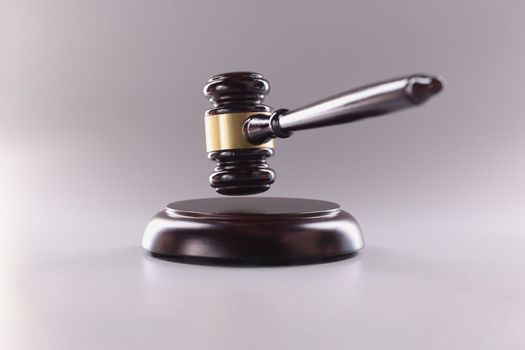 Brown wooden judge gavel in air closeup. Law justice or auction sale concept