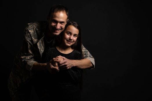 military man and daughter on a black background