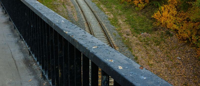 Railroad bridge railway. Autumn colors on abandoned rail tracks. Autumn landscape from the bridge and railroad. view from above, 