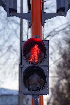 Red light on a pedestrian traffic light. Safe crossing of the road by pedestrians. 