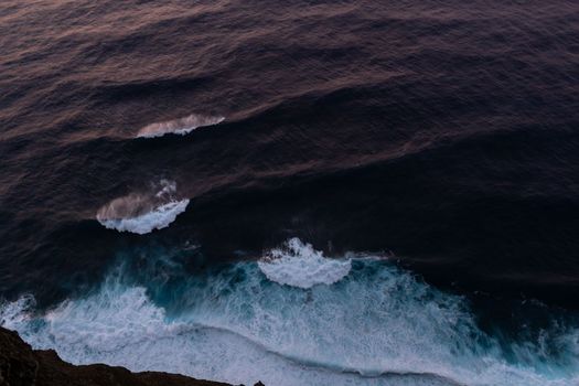 ocean surf waves at sunset view from above. High quality photo