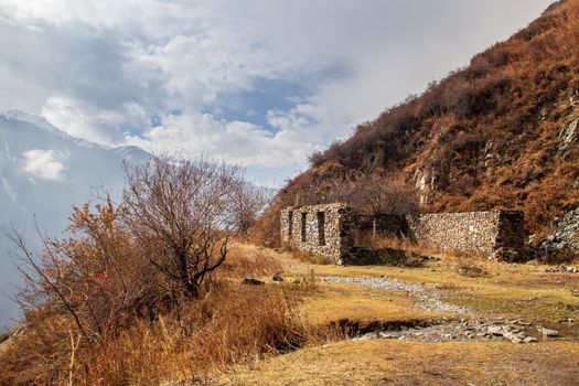 Ruin on the way in autumn mountain gorge popular hiking trail The Old Japanese Trail in the Great Almaty Gorge in Kazakhstan.