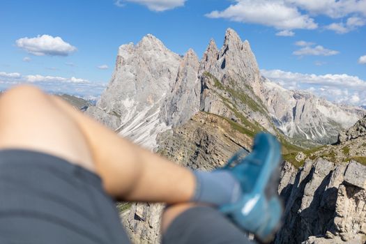 relaxing hiker legs against summer Dolomites peaks High quality photo
