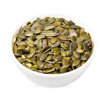 Bowl of pumpkin seeds isolated on white. Top view. Organic food