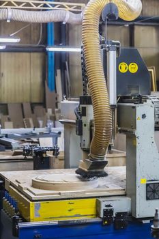 CNC machine cuts a round piece at the factory.