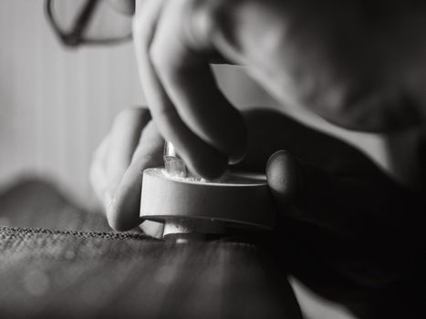 violinmaker working on a handmade contemporary stringed instrument scroll