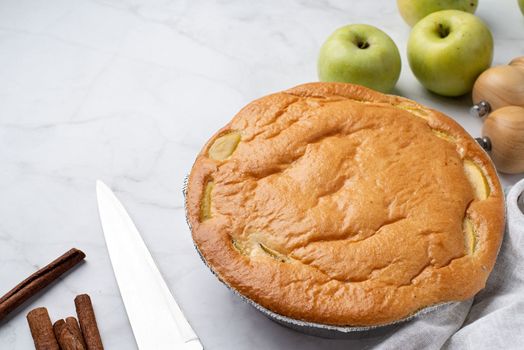 Traditional charlotte apple pie charlotte on concrete table with fresh apple and cinnamon