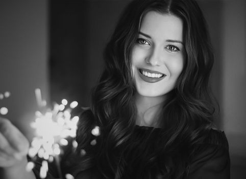 Holiday magic, Christmas and New Year celebration, happy woman with sparklers, portrait