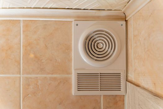 ventilation grate and exhaust fan in the toilet. Air exchange in the apartment. High quality photo