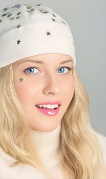 Happy holidays, beautiful woman in white benny hat, and best wishes this Christmas and throughout the year. Smiling blonde girl with holiday spirit, celebrating the winter season.