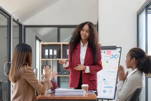 Asian business workgroup designers team with asian woman leader discuss paperwork financial report statistical data, forecasting working on common project. Brainstorm, briefing activity concept..