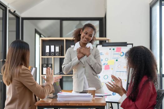 Asian business workgroup designers team with asian woman leader discuss paperwork financial report statistical data, forecasting working on common project. Brainstorm, briefing activity concept..