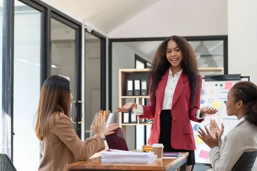 Asian business workgroup designers team with asian woman leader discuss paperwork financial report statistical data, forecasting working on common project. Brainstorm, briefing activity concept..