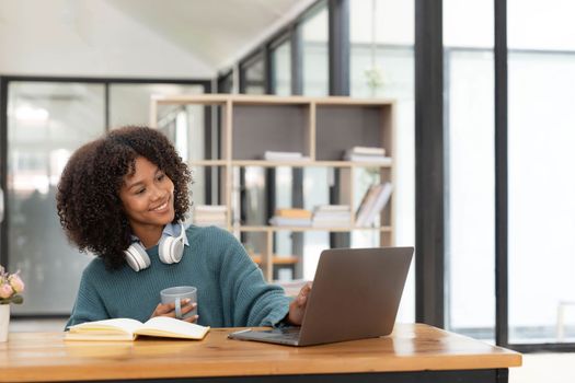 Young asian woman wearing headset working on computer laptop at house. Work at home, Video conference, Video call, Student learning online class..