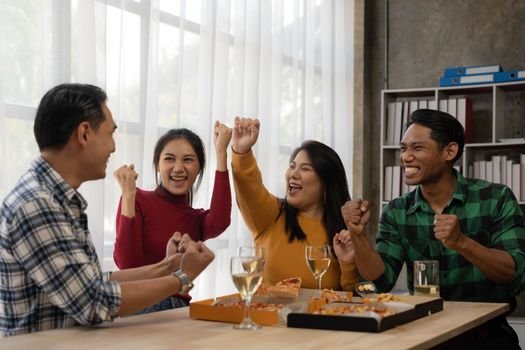 Group of asian friends eating pizza during party at home. Happy asian people having fun together, eating pizza food and beer together with happiness and fun