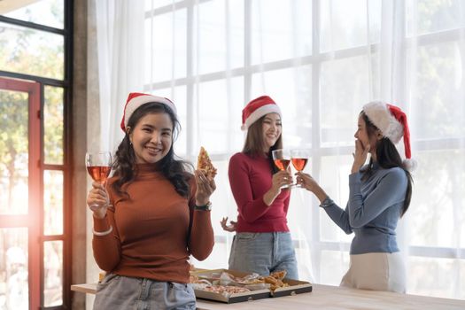 Group of young asian office girl friends having fun, talking and eating pizza together with happiness and fun. Lifestyle Concept.