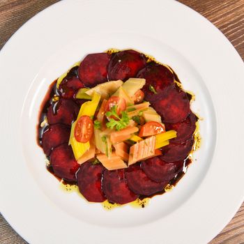 Fresh salad with raw beetroot, multicoloured chard, cherry tomato, sweet green chilli, coriander, pomegranate melange and sumac dressing, High quality photo
